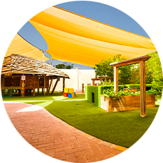 A playground with a yellow canopy.