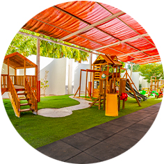 A children's play area with wooden playground equipment.
