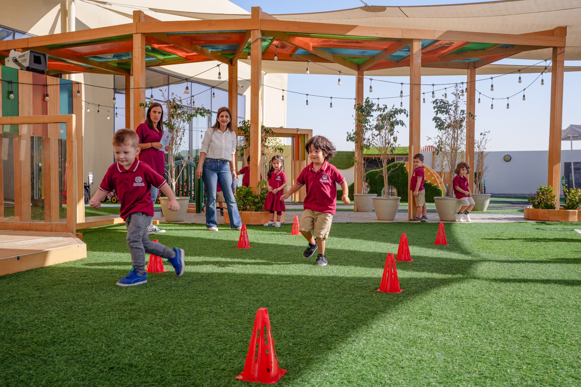 Redwood educators supporting children through an outdoor movement challenge